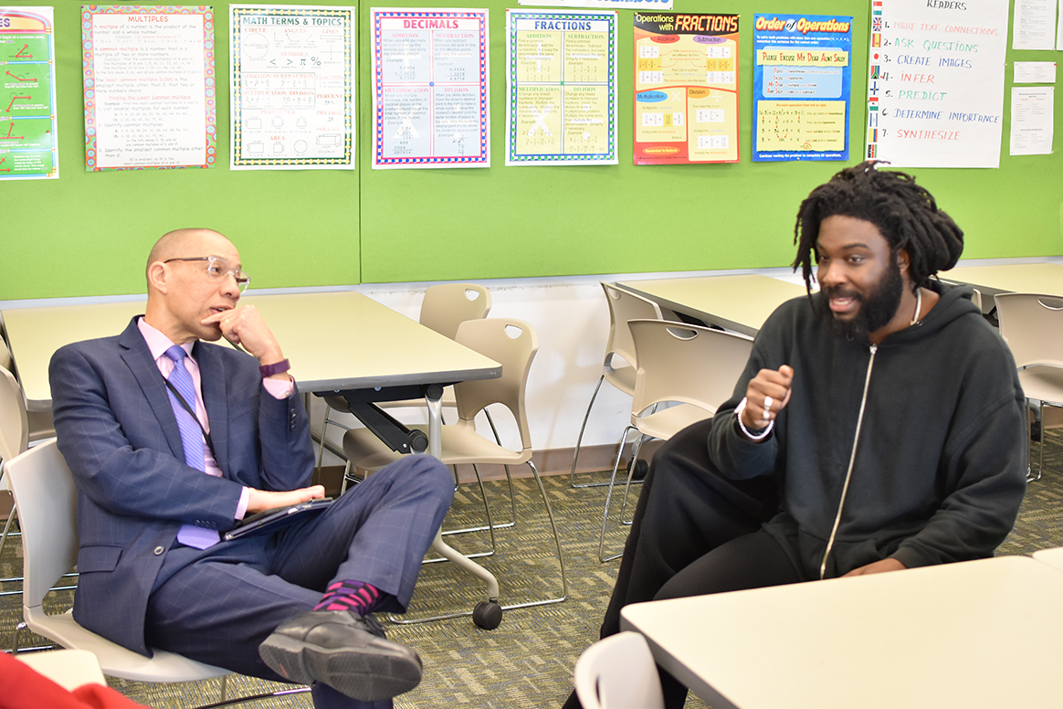 QPL President and CEO Dennis M. Walcott talks with Jason Reynolds at Central Library.